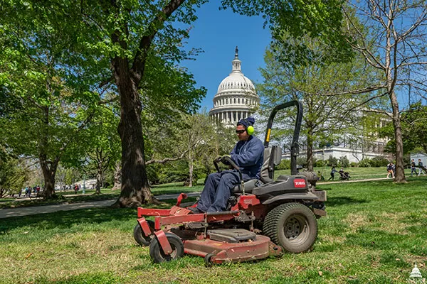 An AOC employee mows the lawn at the U.S. Capitol.