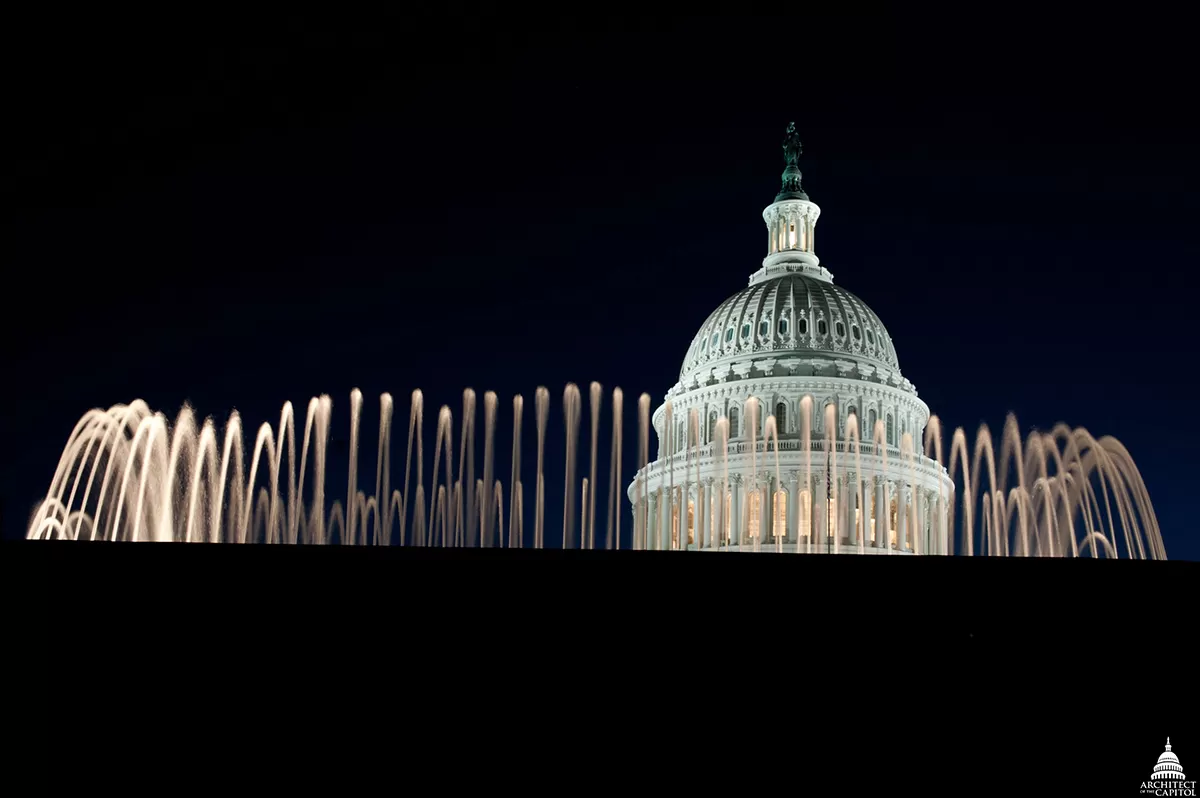 The Capitol Dome at night, as seen behind one of the East Front Olmsted fountains.