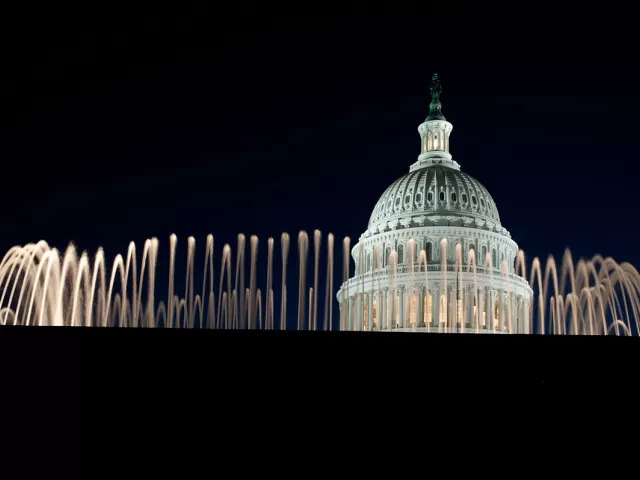 The Capitol Dome at night, as seen behind one of the East Front Olmsted fountains.