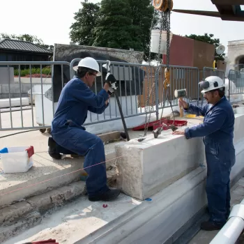 Two people working with stone.