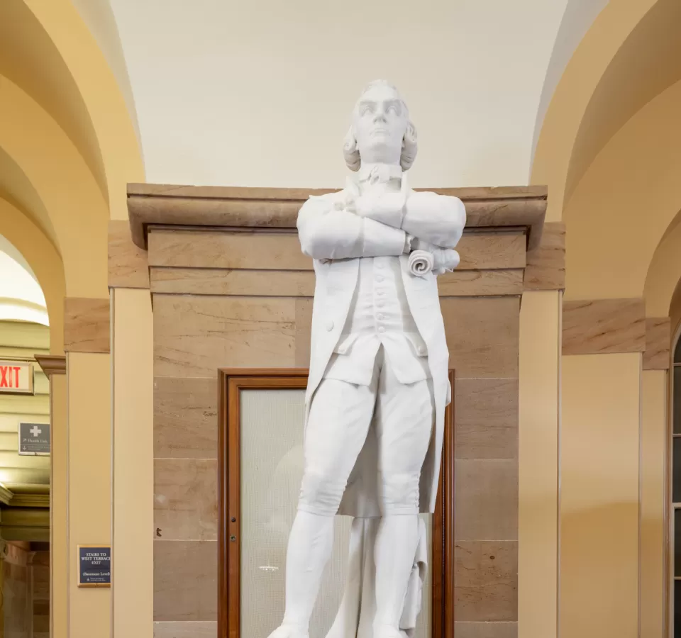 Marble statue of a person standing.