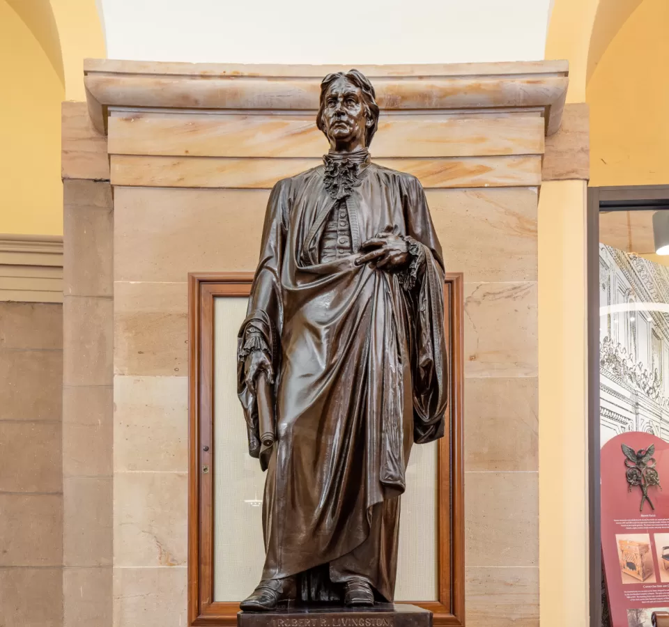 Bronze statue of a person standing.