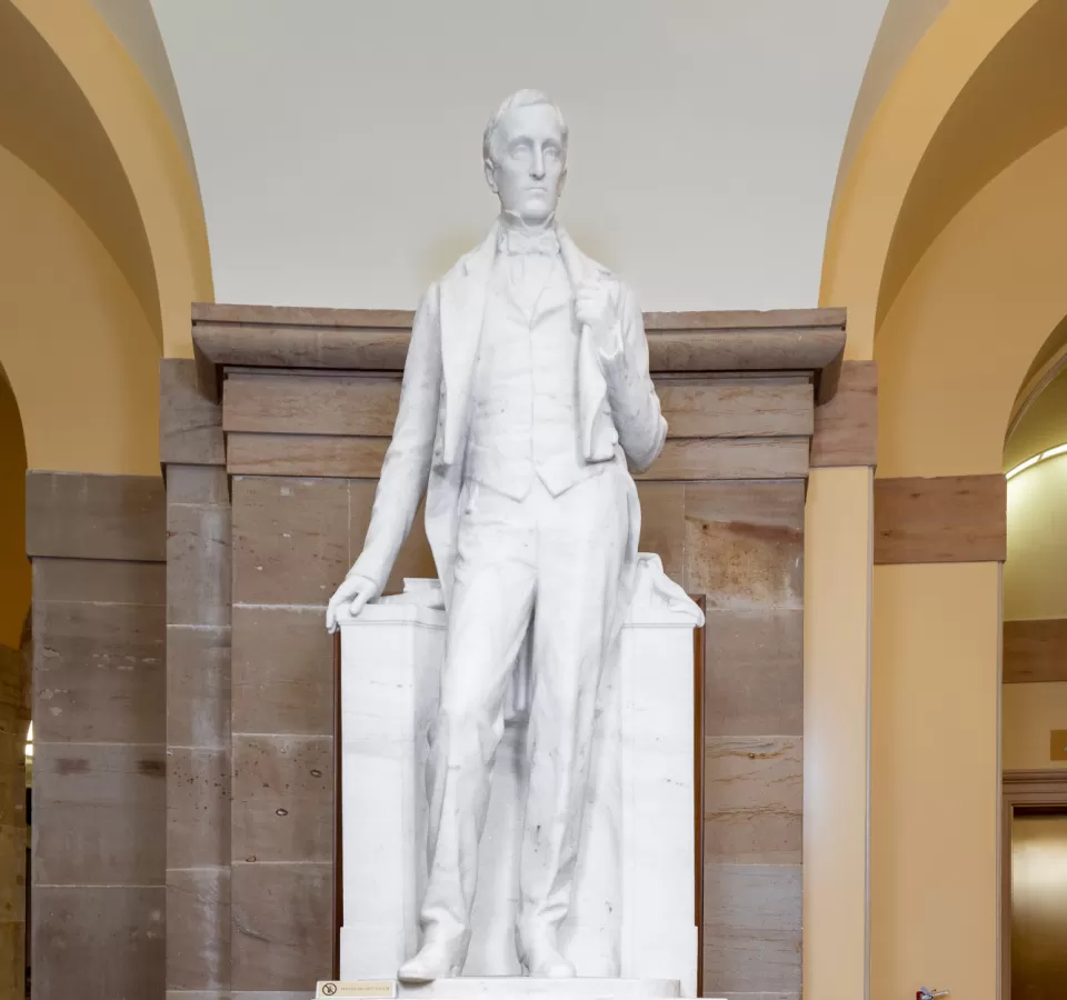 Marble statue of a person standing.