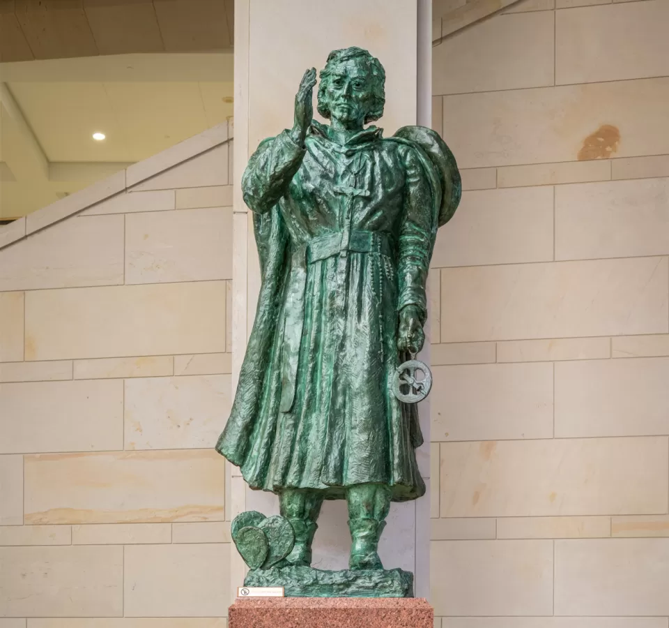 Bronze statue of a person standing.