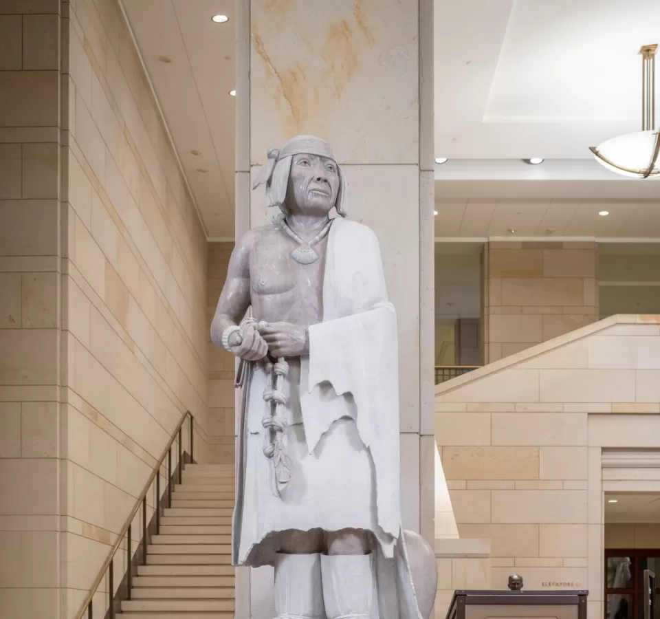 Marble statue of a person standing.