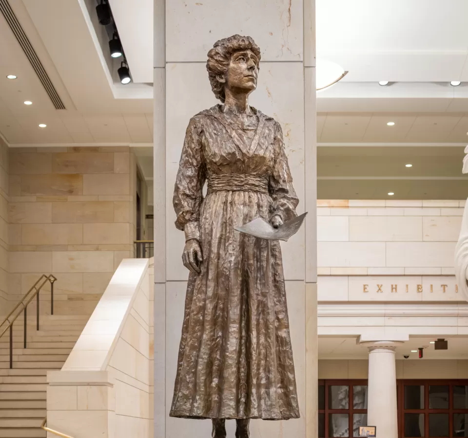 Bronze statue of a person standing.