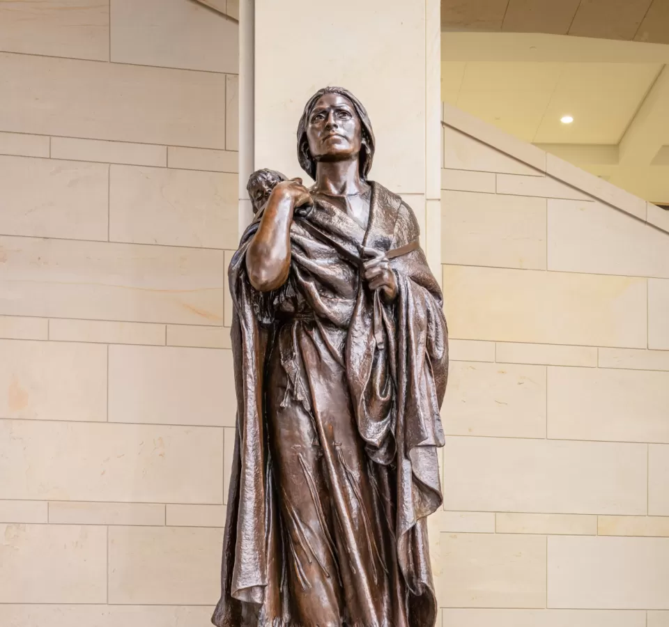 Bronze statue of a person standing.