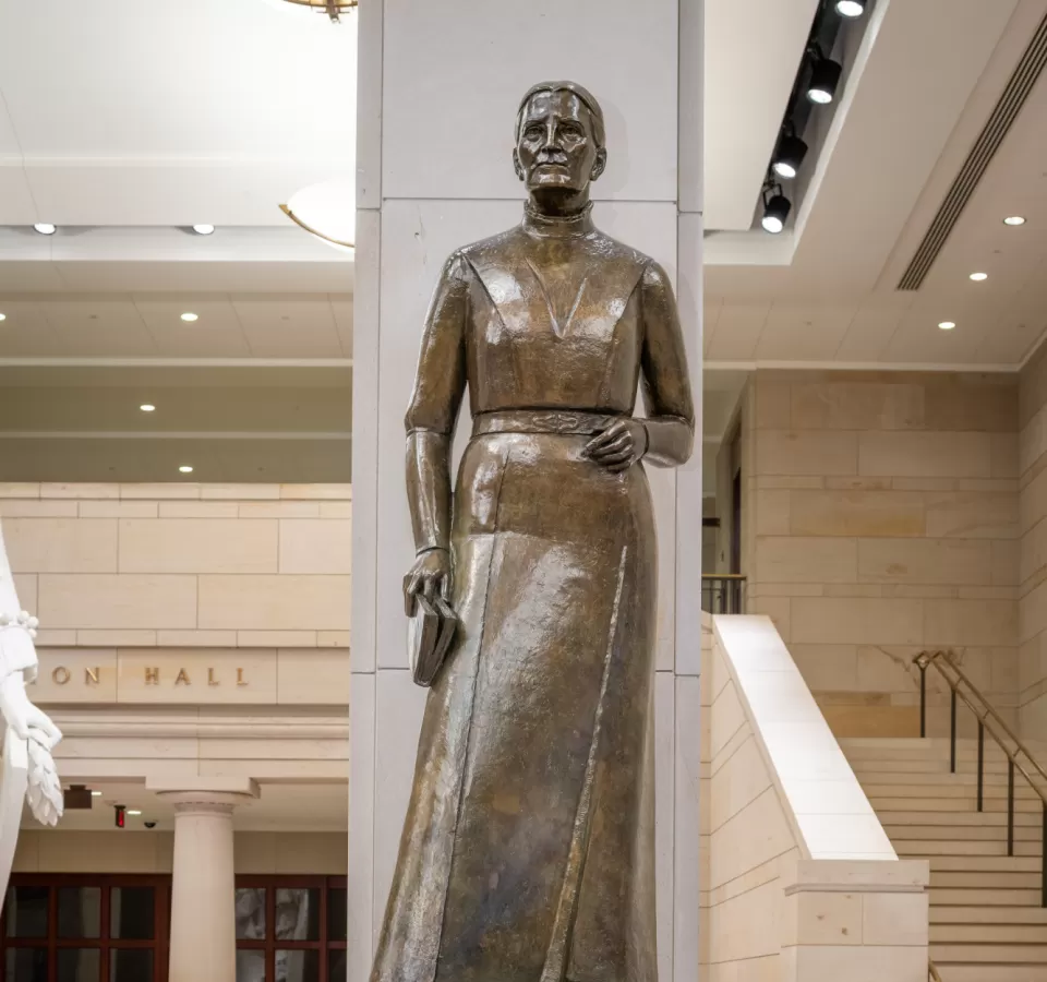 Bronze statue of a person standing.