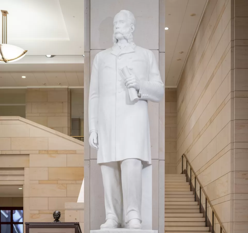 Marble statue of a person standing.