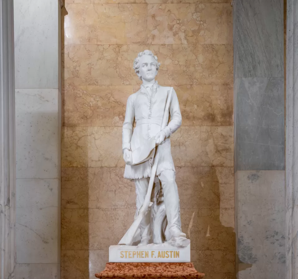 Marble statue of a person standing.