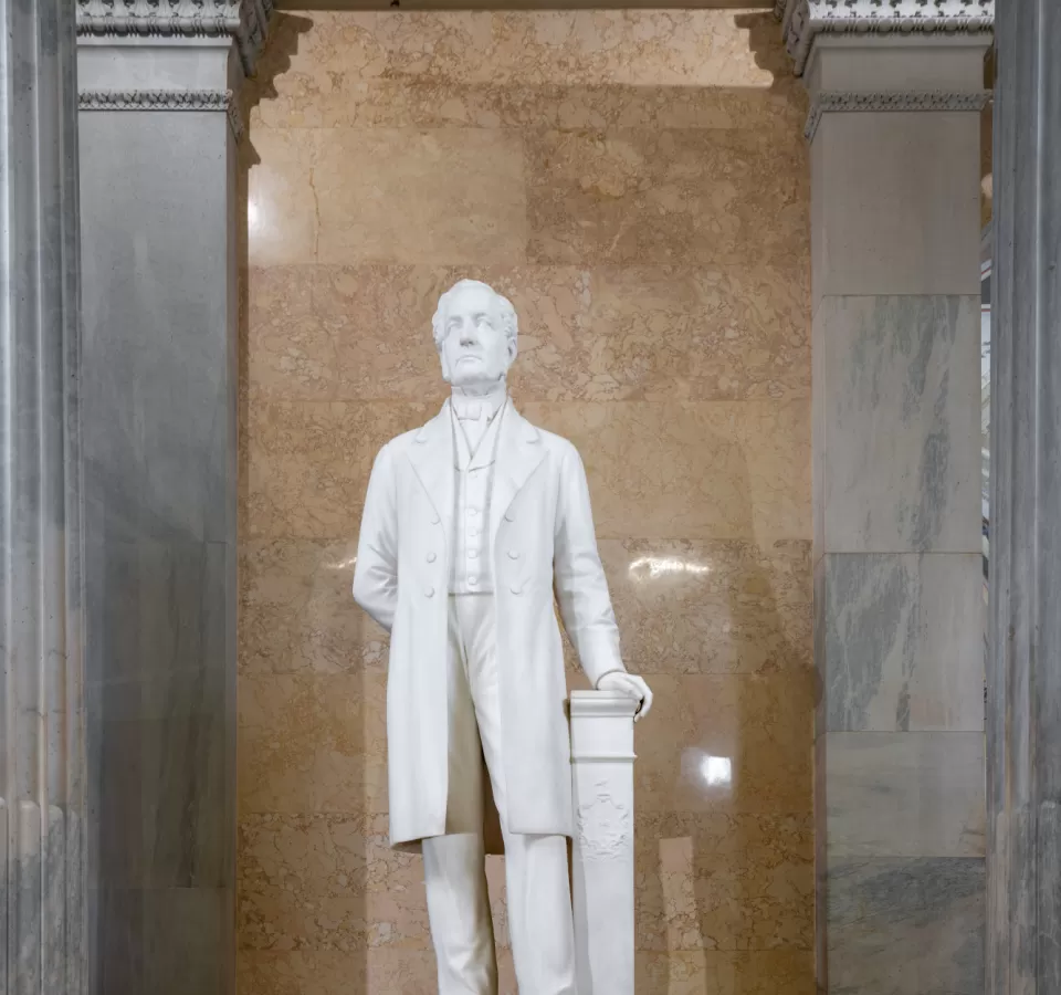 Marble statue of a person standing.