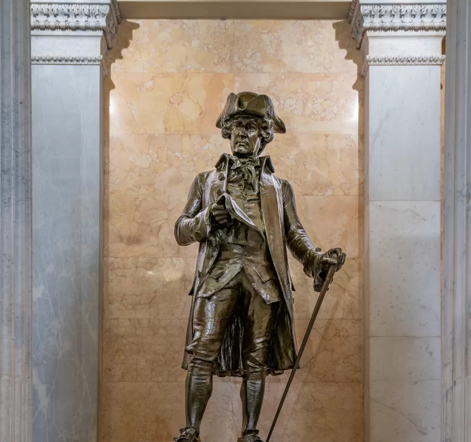 Bronze statue of a person standing.