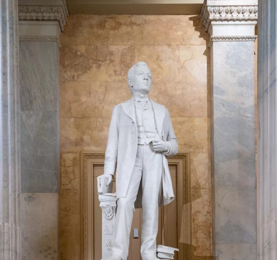 Marble statue of a person standing.