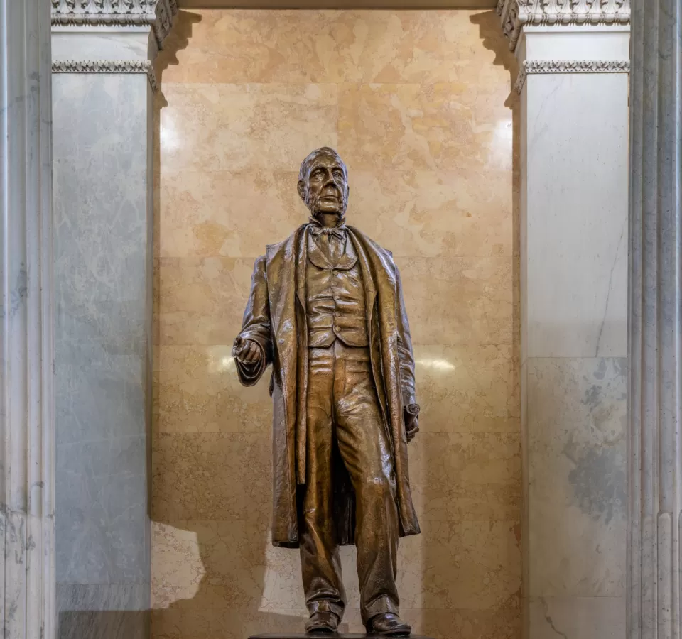 Bronze statue of a person standing.