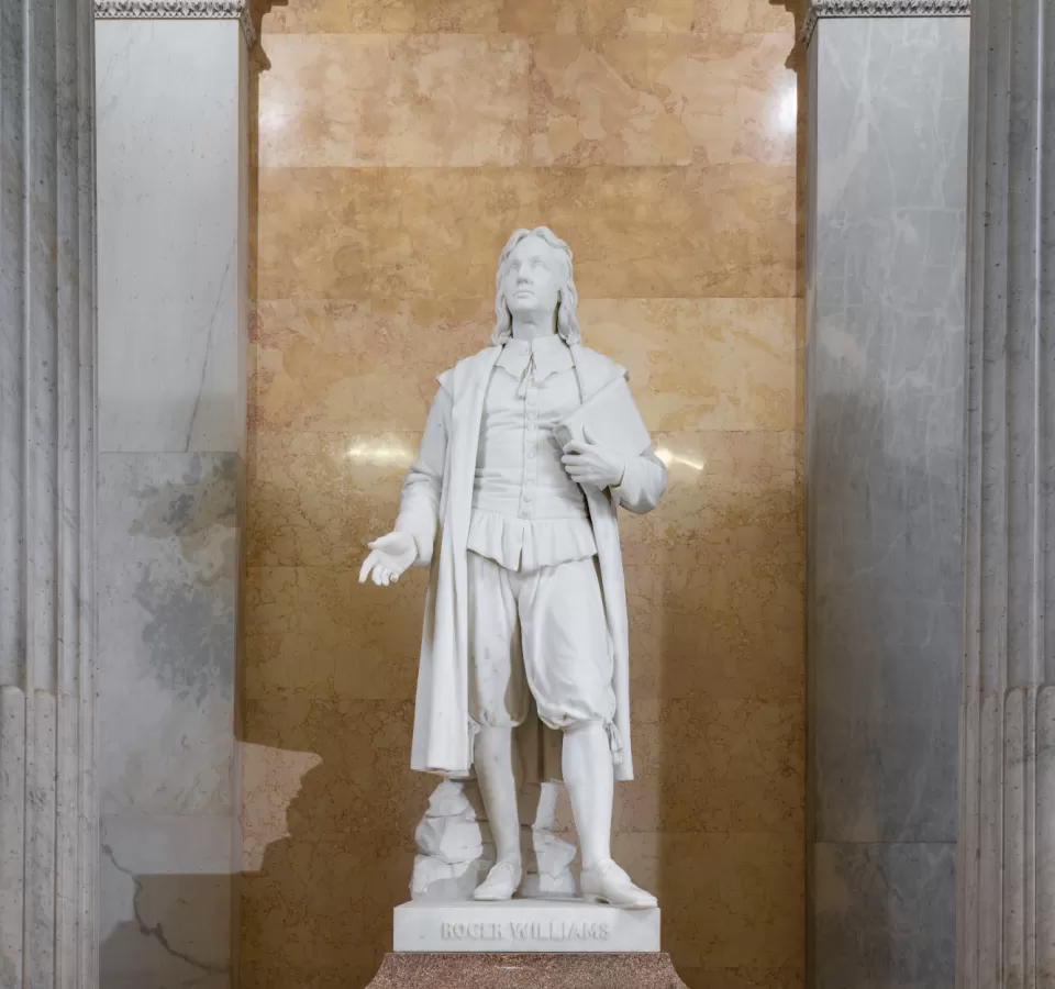 Marble statue of a person standing.