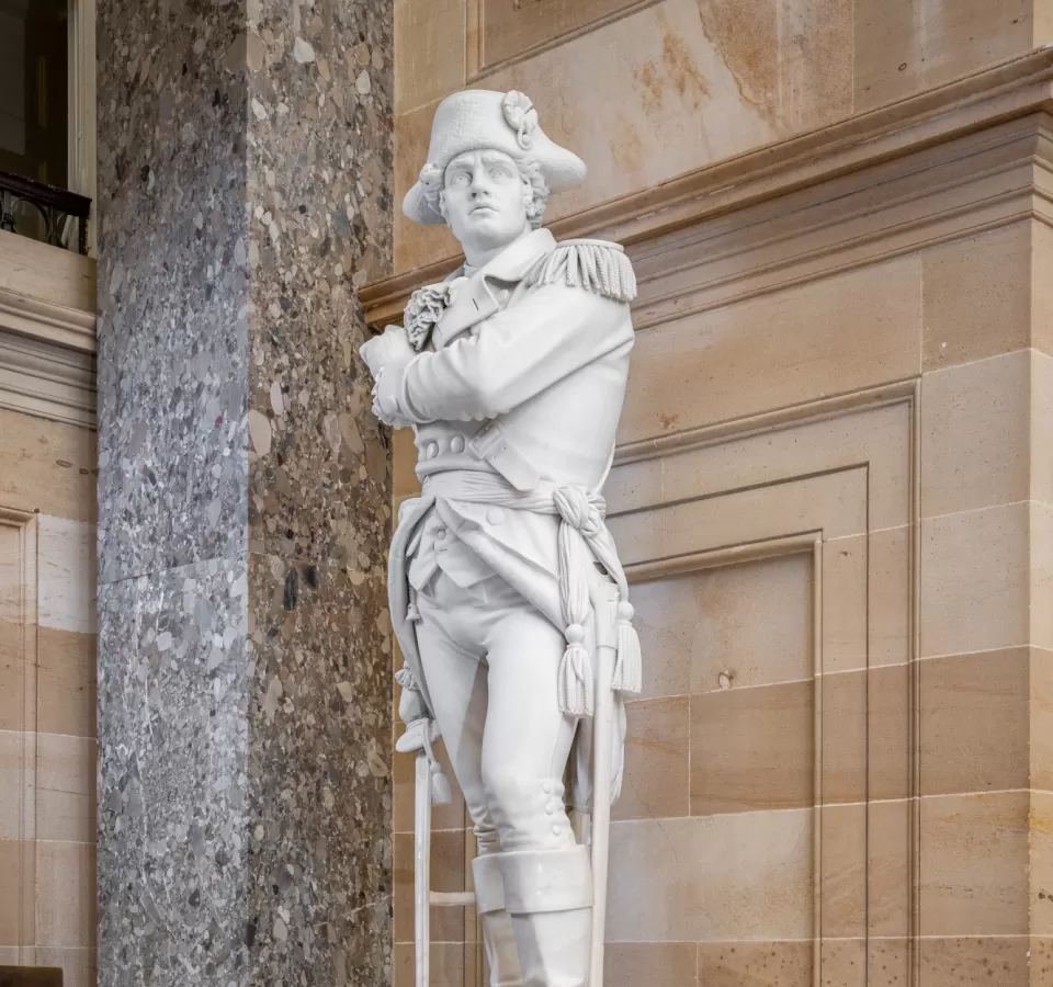 Marble statue of a person standing.