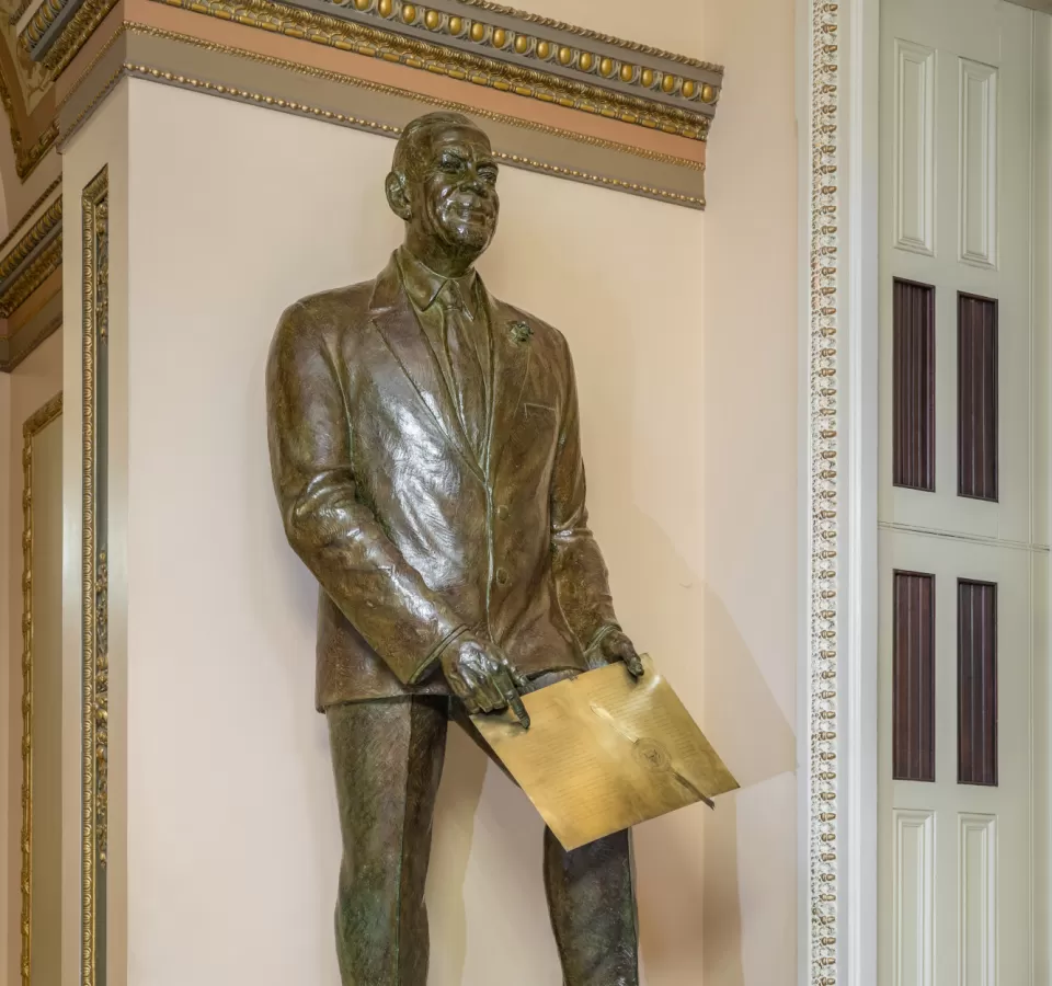 Bronze statue of a person standing.