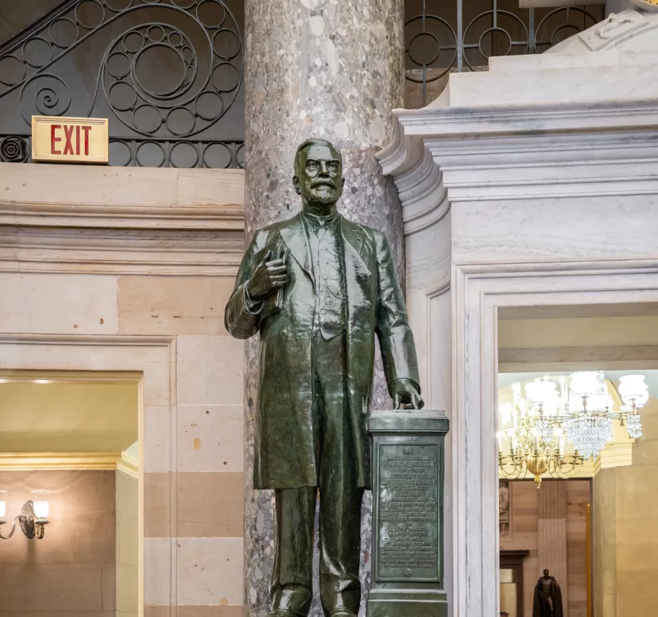 Bronze statue of a person standing.