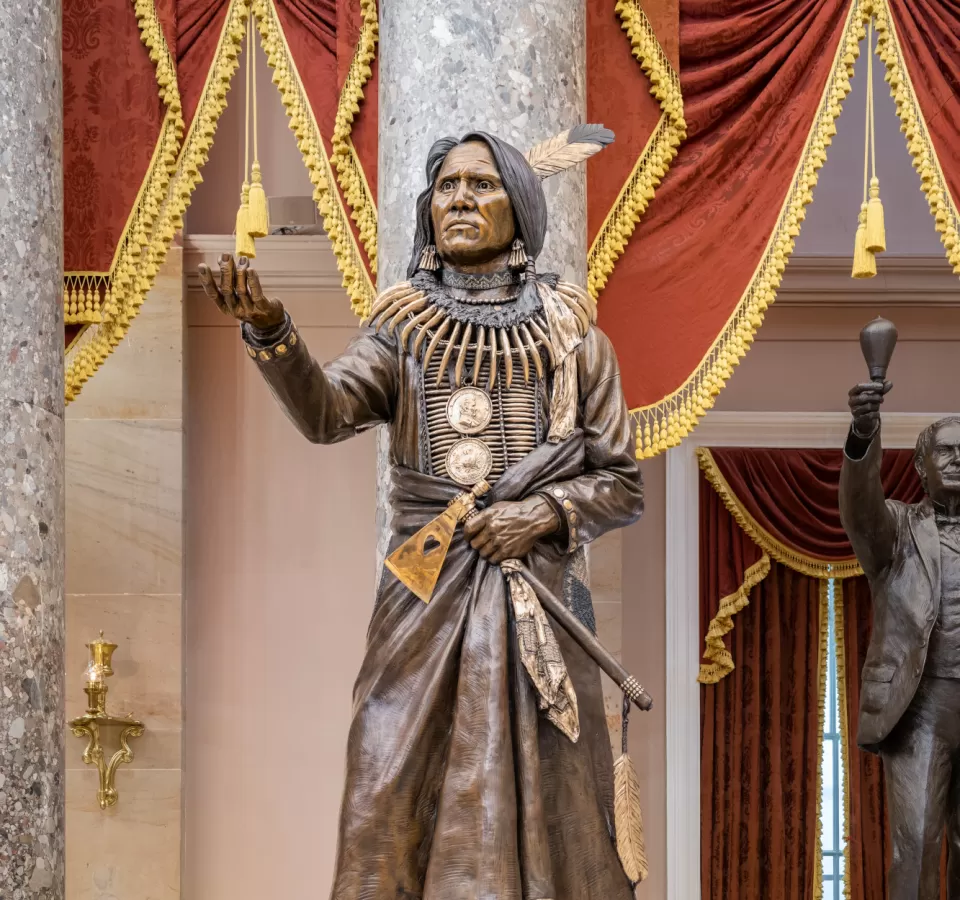 Bronze statue of a person standing.