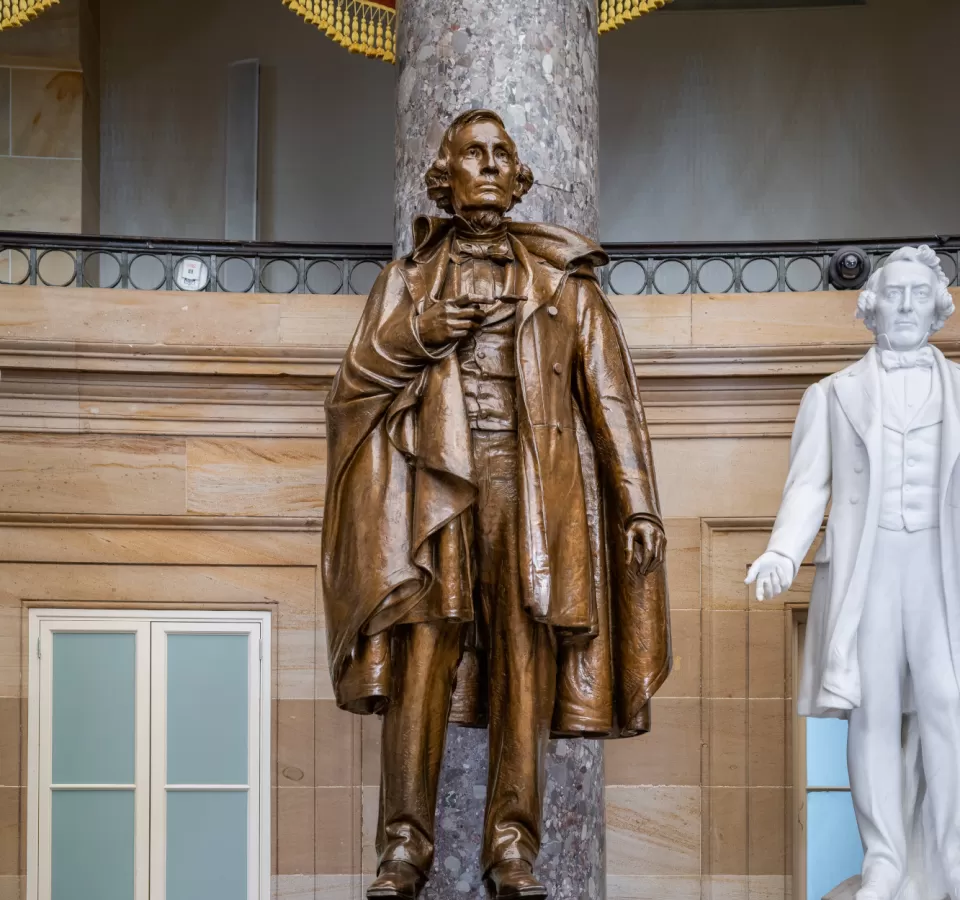 Bronze statue of a person standing.