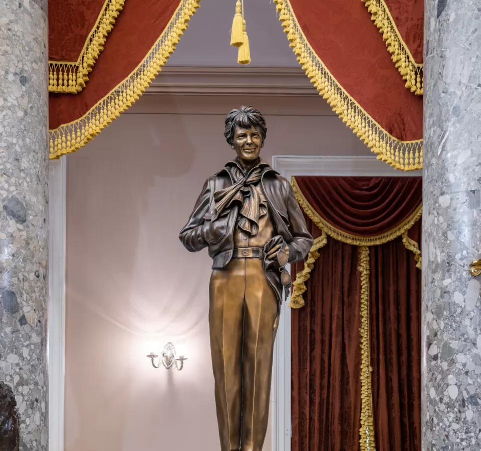 Bronze statue of a person standing.