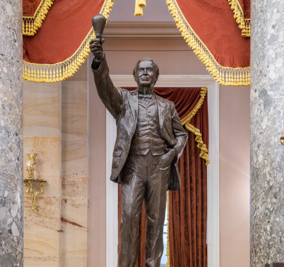 Bronze statue of a person standing.