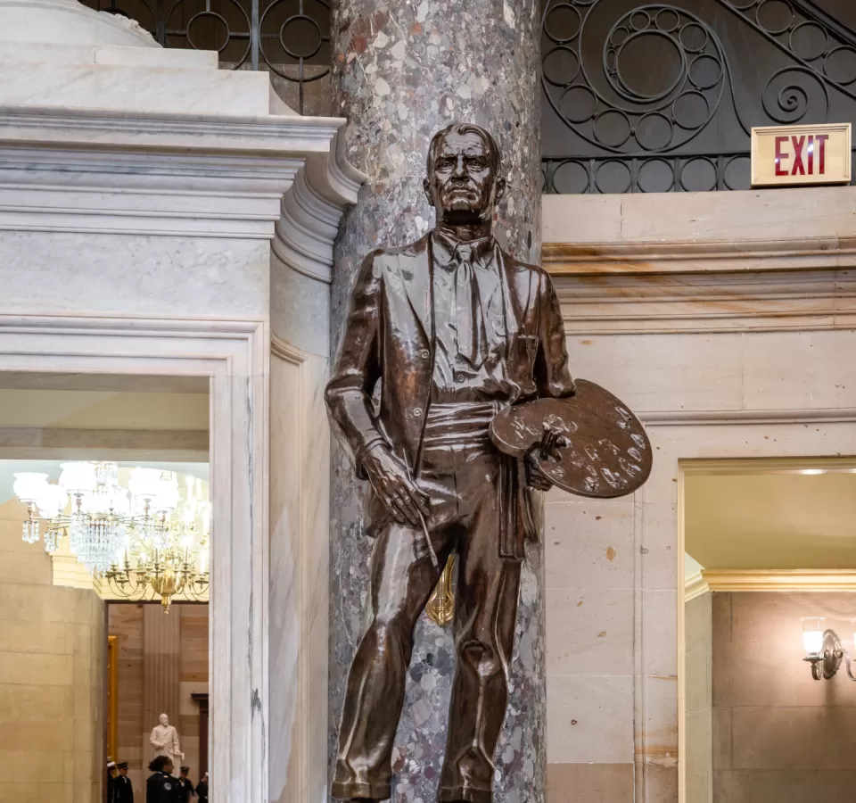 Bronze statue of a person standing.