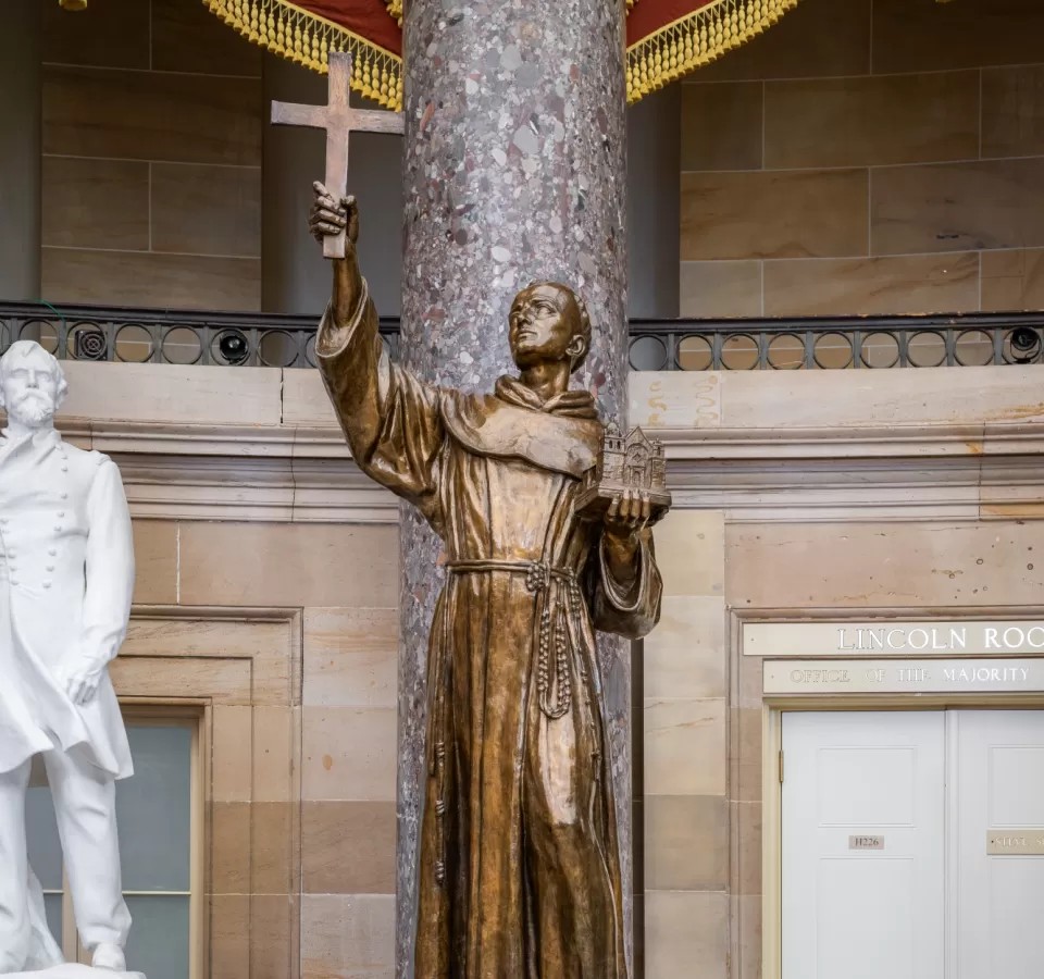 Bronze statue of a person standing.