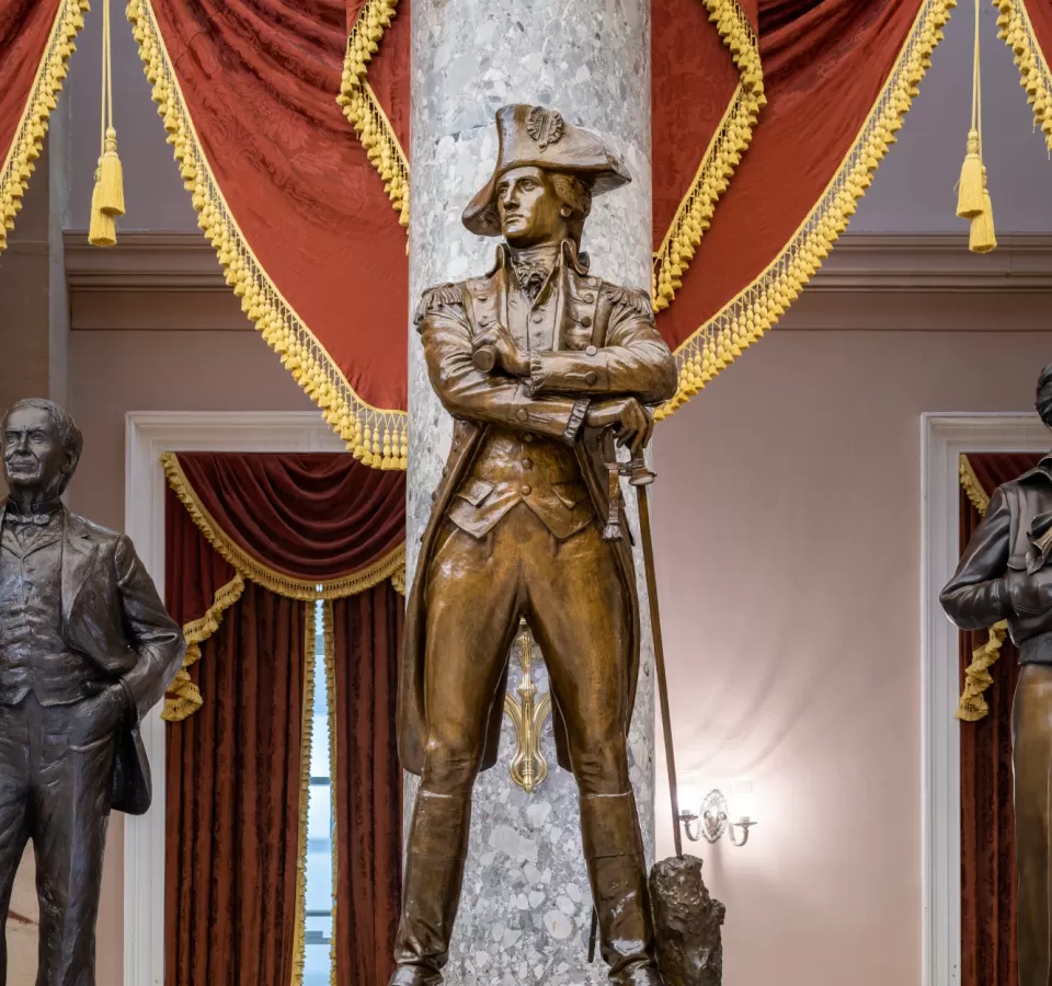 Bronze statue of a person standing.