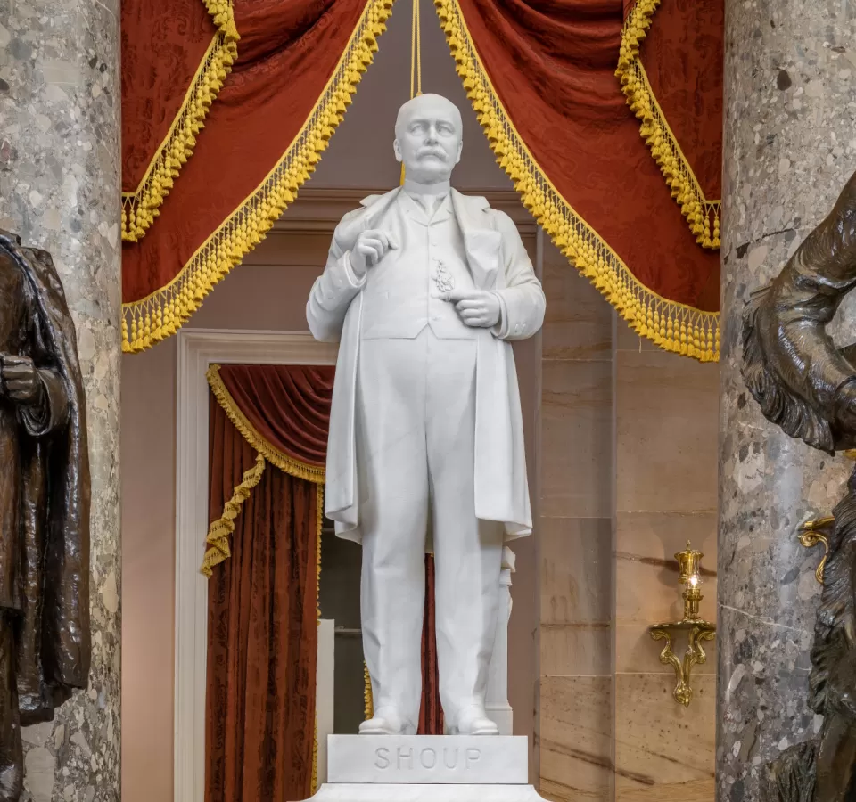 Marble statue of a person standing.