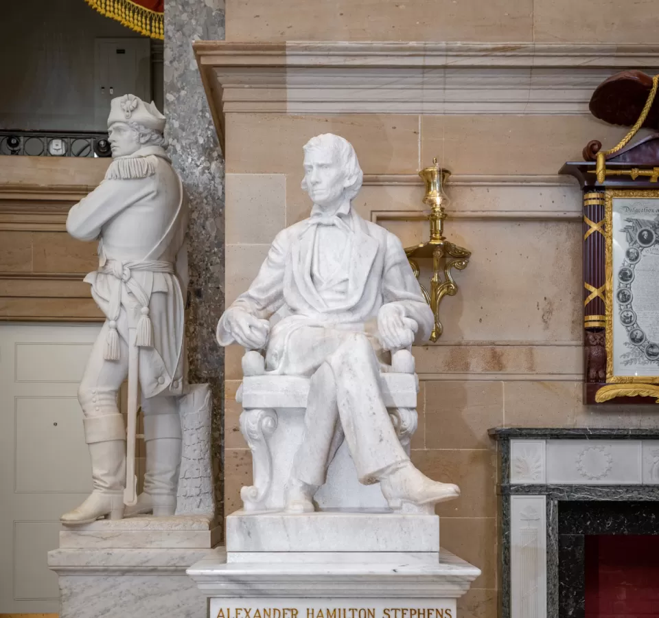 Marble statue of a person sitting.