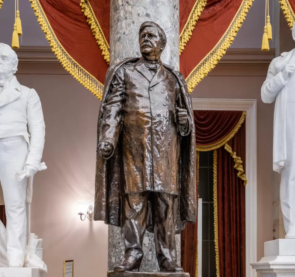 Bronze statue of a person standing.