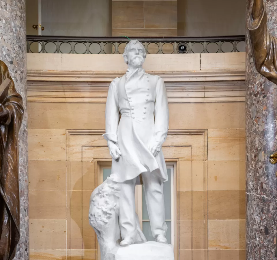 Marble statue of a person standing.