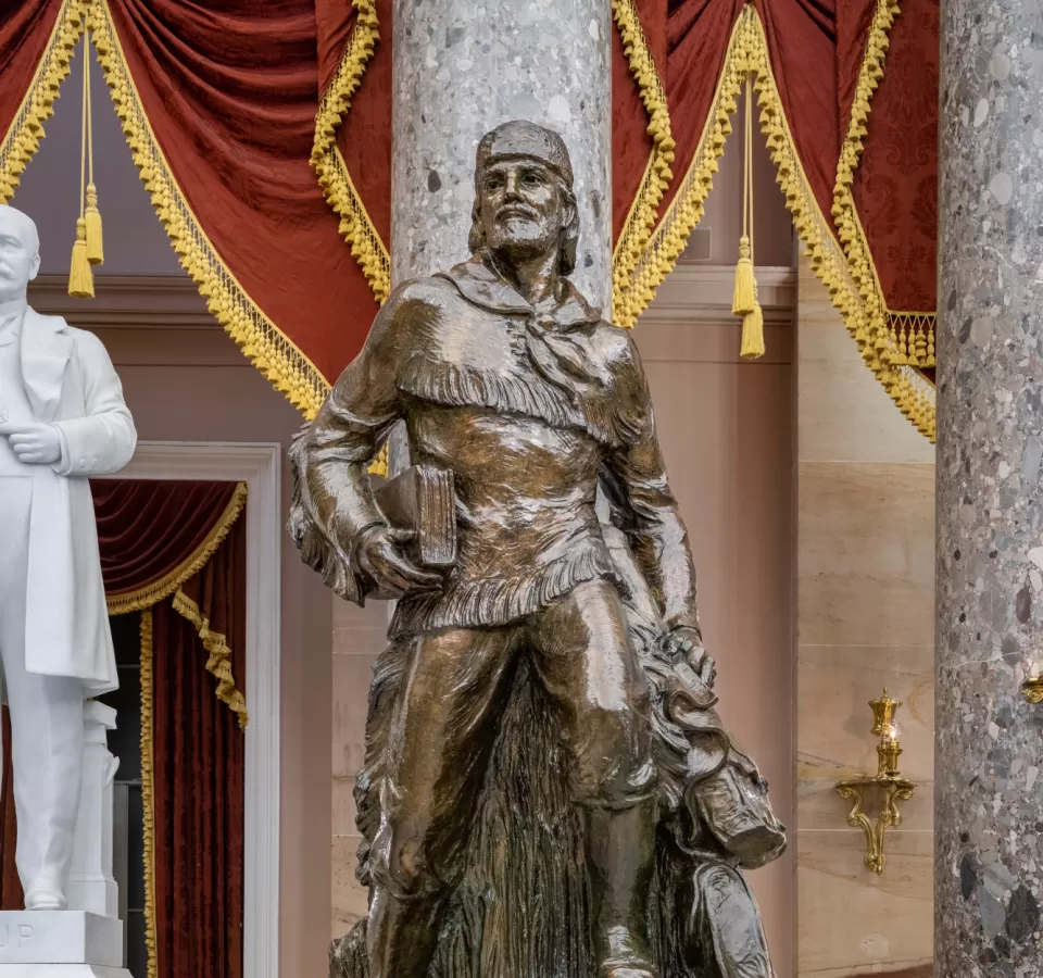 Bronze statue of a person standing.