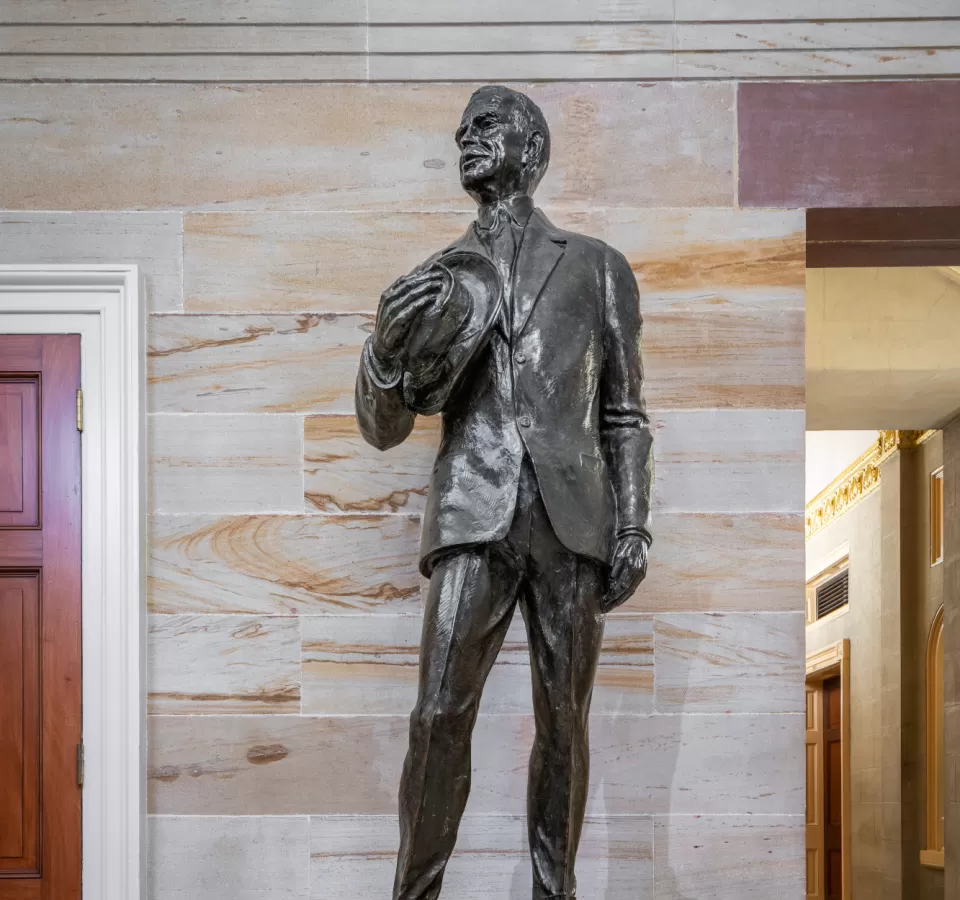 Bronze statue of a person standing.