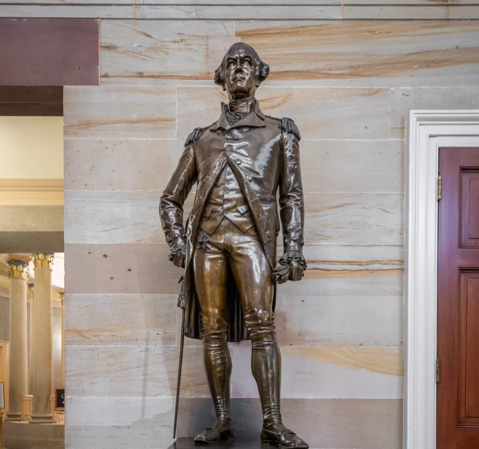 Bronze statue of a person standing.