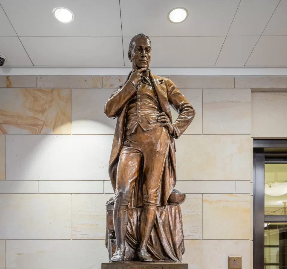 Bronze statue of a person standing.