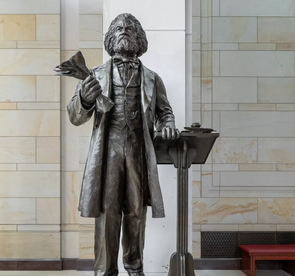 Bronze statue of a person standing.