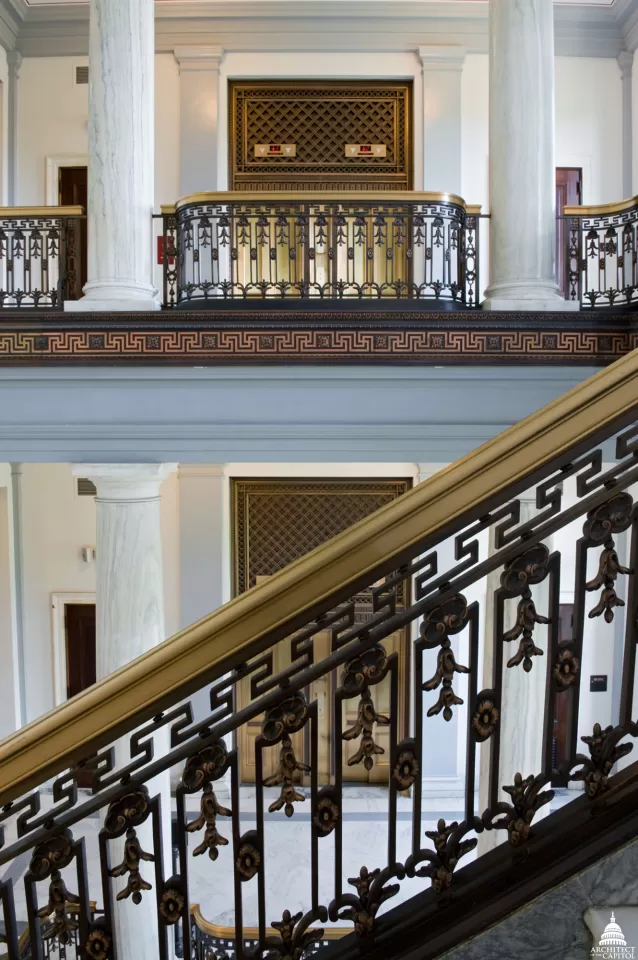View of elevators and stair railings inside the Russell Senate Office Building.