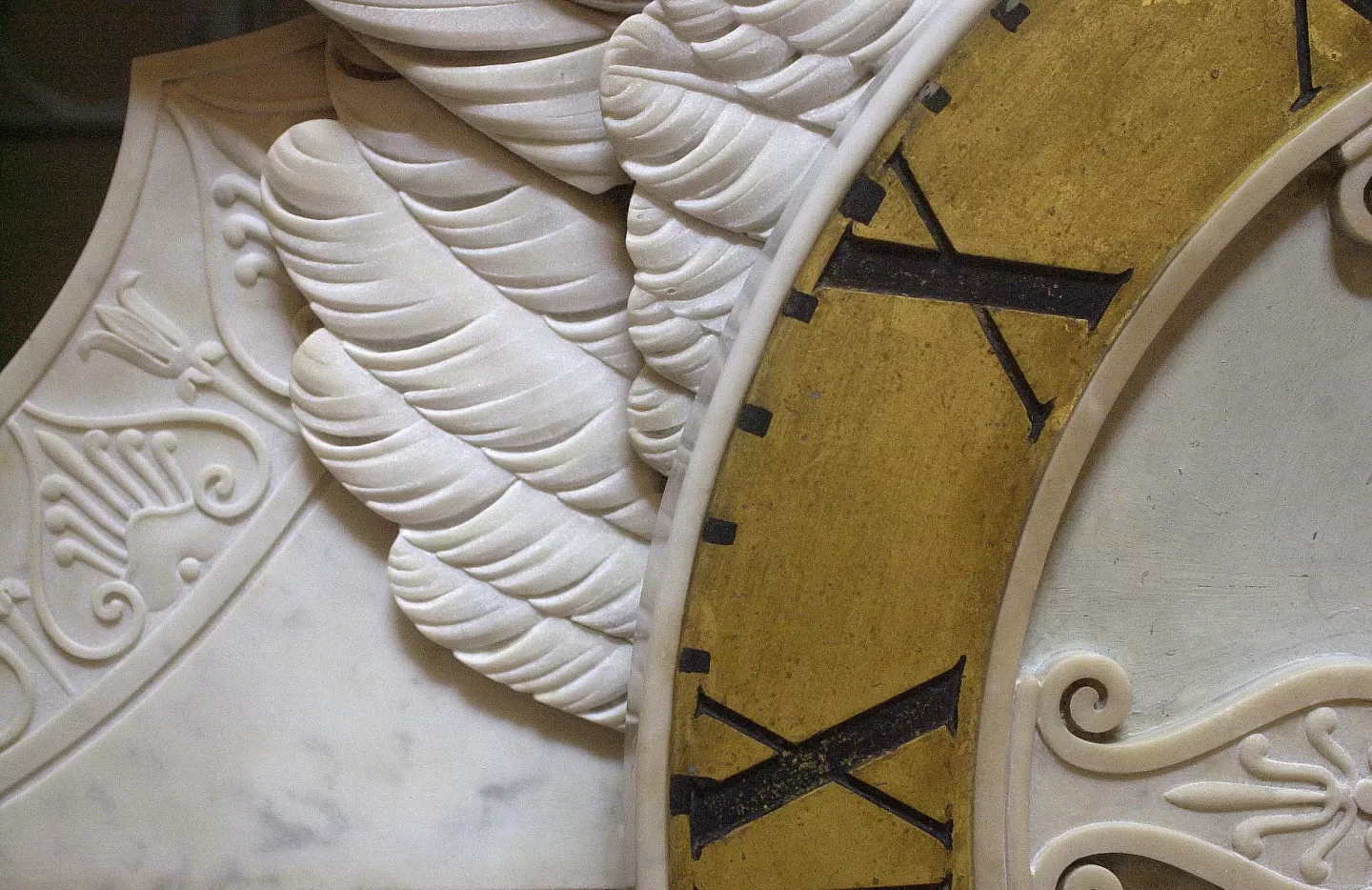 Marble sculpture and portion of clock face.