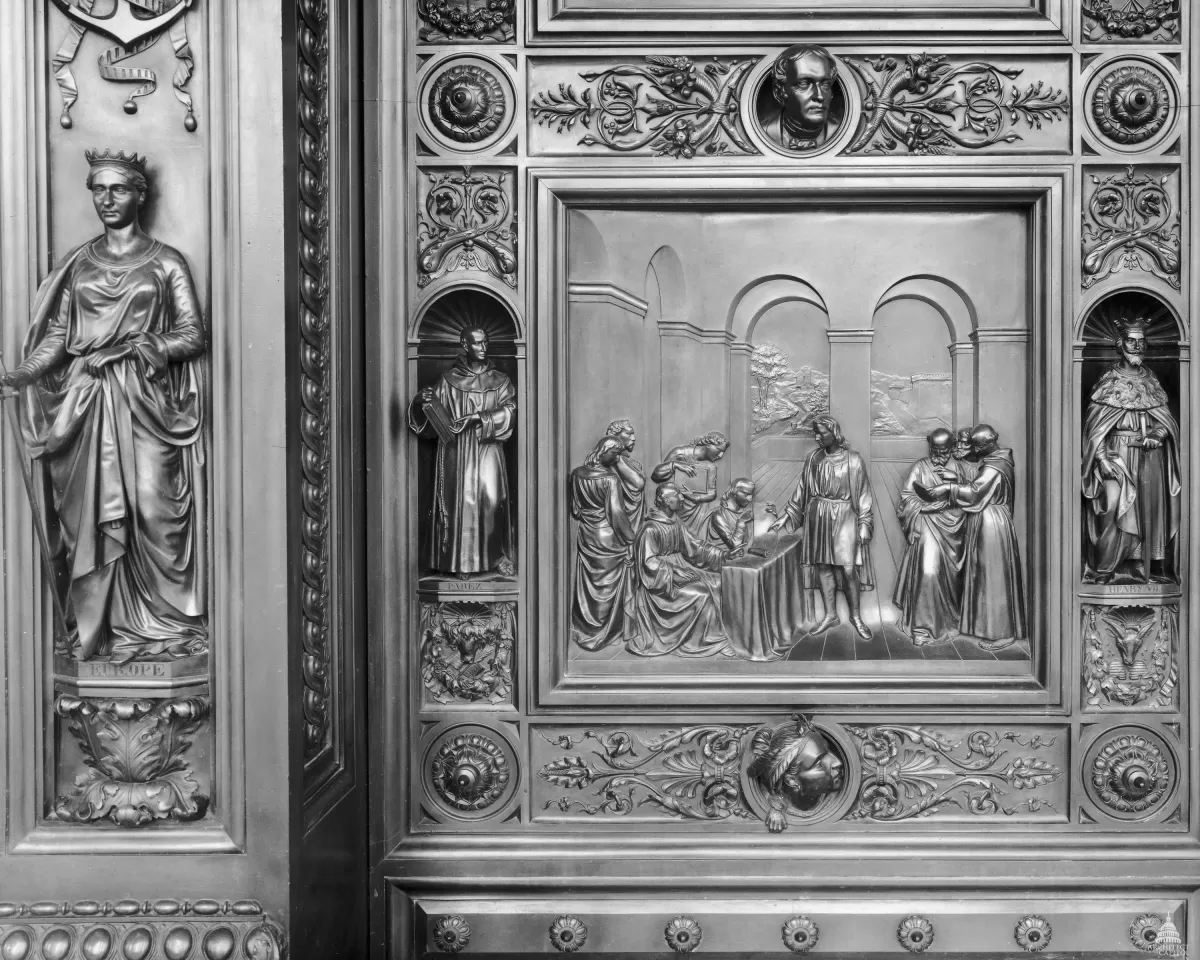 Columbus Doors, Left Valve: Columbus Before the Council of Salamanca (1487)