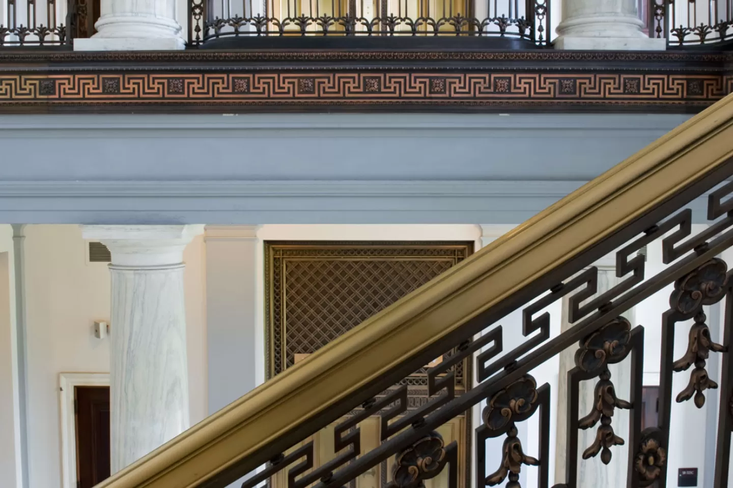 View of elevators and stair railings inside the Russell Senate Office Building.
