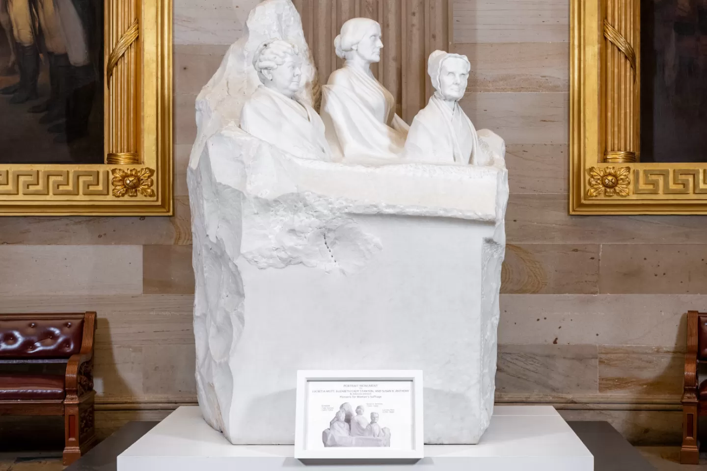 Marble sculpture of three partial figures.