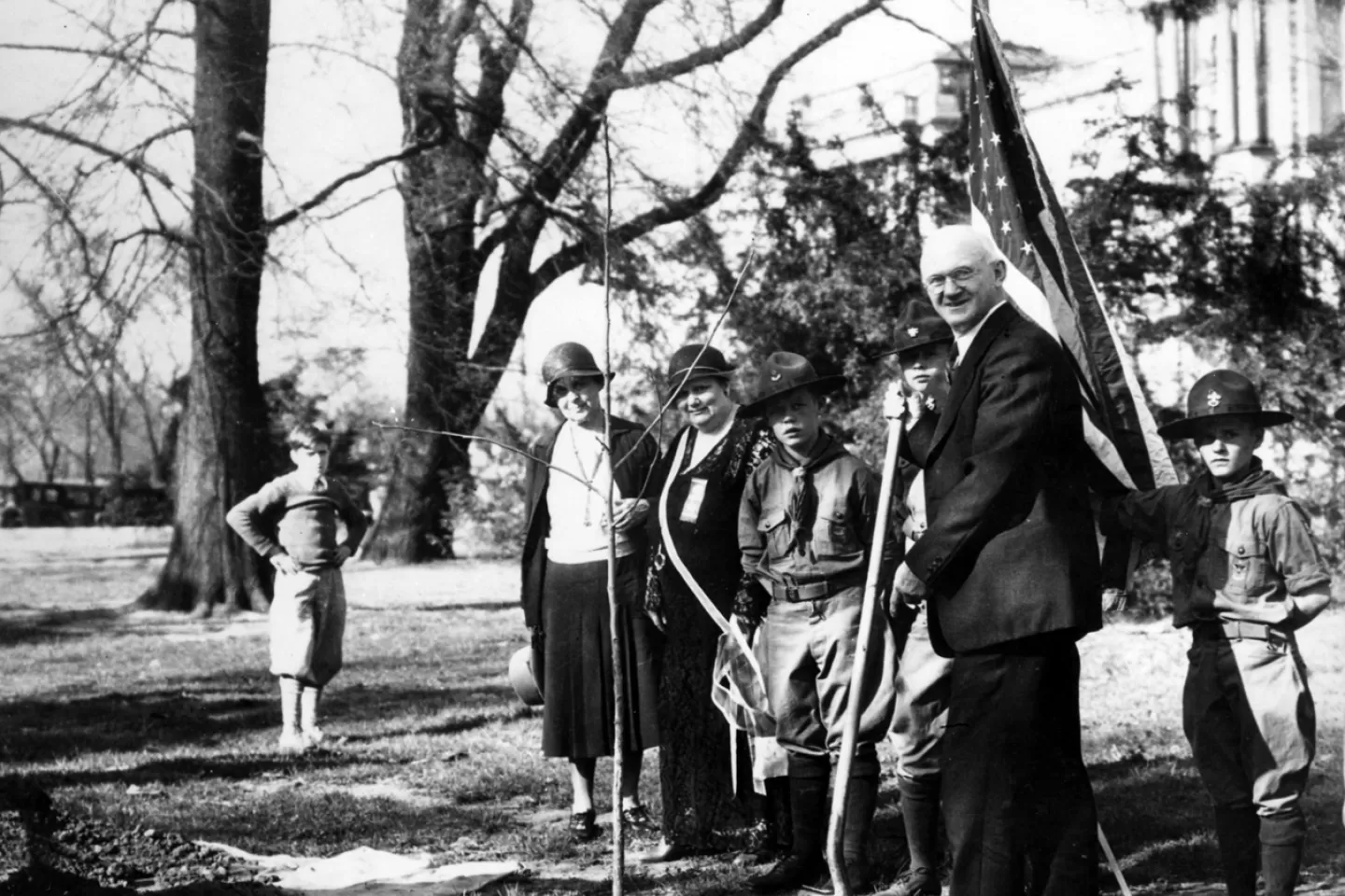 People standing holding shovels.