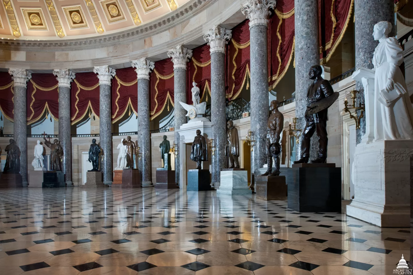 Columns in a room with statues.