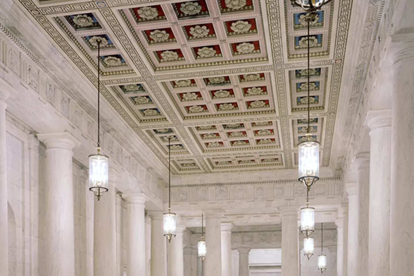 The main corridor, known as the Great Hall, has double rows of monolithic marble columns which rise to a coffered ceiling.