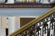 View of elevators and stair railings inside the Russell Senate Office Building.