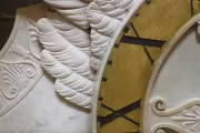Marble sculpture and portion of clock face.