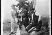 Architect of the Capitol employees take a self-portrait (note string in hand of individual all in white) while preserving the Statue of Freedom in 1913.