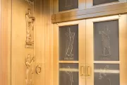 The bronze and glass doors of the John Adams Building.